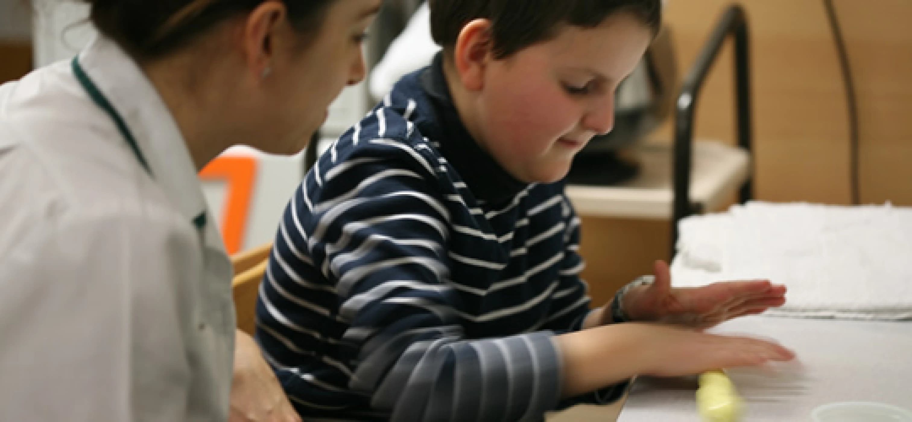 Boy with Barth Syndrome playing at a table