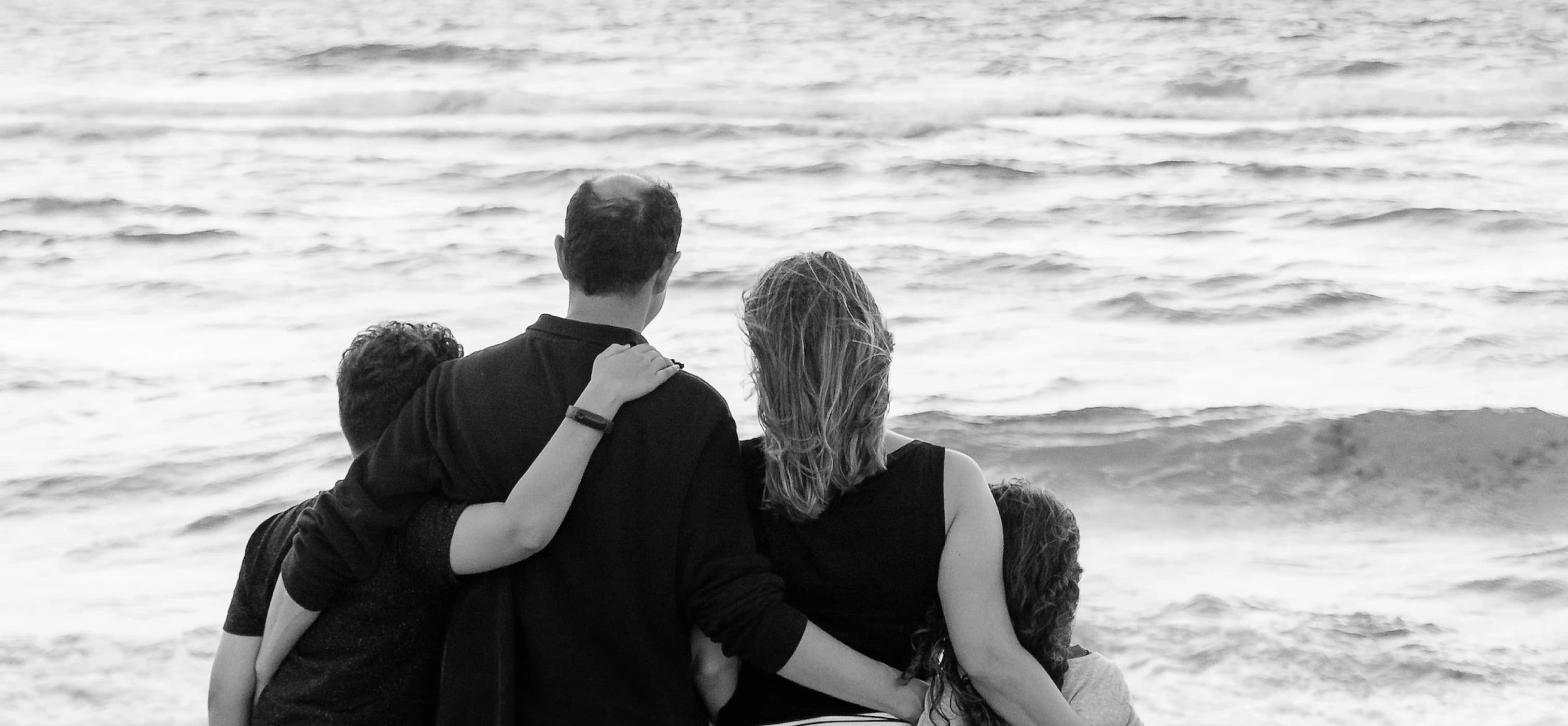 Family looking out to sea at the beach